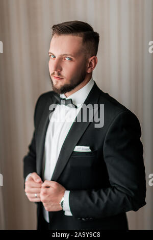 close up. serious man buttoning his jacket. Stock Photo