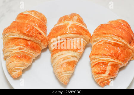 Plain croissant on white background - Image Stock Photo