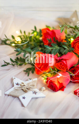 Composition: red roses with boxwood, garlands and star Stock Photo