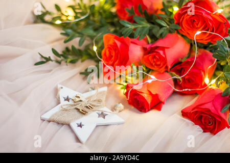 Composition: red roses with boxwood, garlands and star Stock Photo