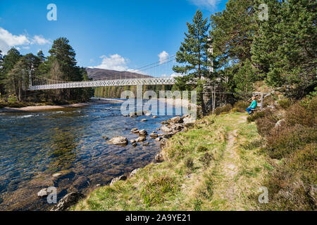 Looking west along River Dee from  A93,  near Braemar, white chain bridge, spring sunlight, Aberdeenshire,  Highland Region, Scotland UK Stock Photo