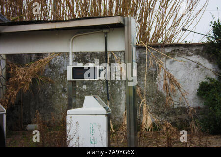 unused dispenser of an old abandoned petrol station over time Stock Photo