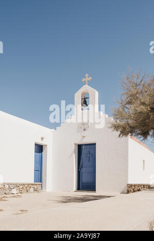 Mykonos, Greece - September 23, 2019: Facade of an orthodox church with a blue door in Mykonos. There is a total of some 600-800 churches, monasteries Stock Photo