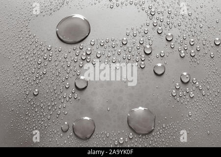 Background of shining water drops on silvery surface, macro Stock Photo