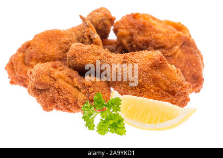 fried chicken pieces with lemon and parsley isolated on white background Stock Photo