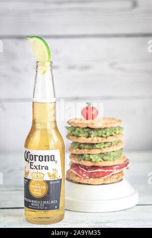 SUMY, UKRAINE - APRIL 05, 2017: Bottle of Corona Extra Beer with crispbread sandwich. Corona is one of the top-selling beers worldwide. Stock Photo