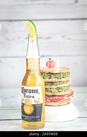 SUMY, UKRAINE - APRIL 05, 2017: Bottle of Corona Extra Beer with crispbread sandwich. Corona is one of the top-selling beers worldwide. Stock Photo