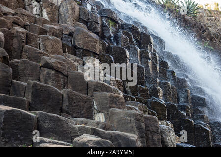 Waterfall and a hanging bridge at basaltic prism canyon at Hidalgo, Mexico. Stock Photo