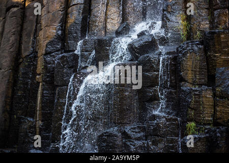 Waterfall and a hanging bridge at basaltic prism canyon at Hidalgo, Mexico. Stock Photo