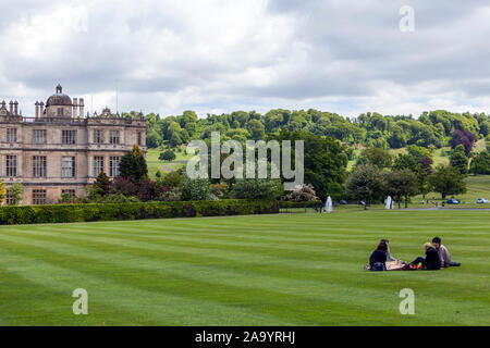 Family seating in the lawn garden in Longleat House, Wiltshire, England, UK Stock Photo