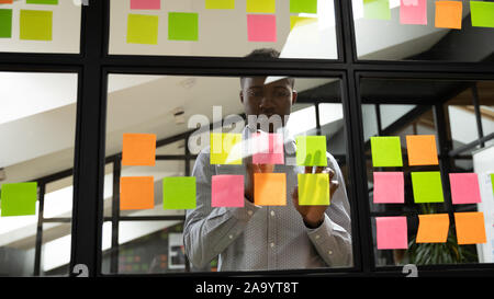 Focused millennial african american male manager organizing working process. Stock Photo