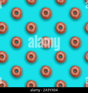 Chocolate glazed doughnuts (donuts) on soft turquoise background Stock Photo