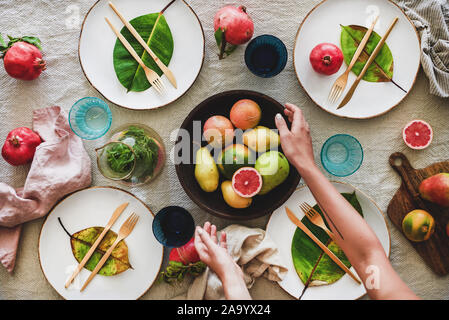 Autumn table setting and female hands over tablecloth Stock Photo