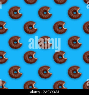 Seamless pattern with bitten chocolate glazed donuts (doughnuts) Stock Photo