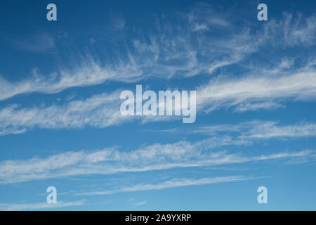 Wispy feathery cirrus clouds covering a blue sky. UK Stock Photo