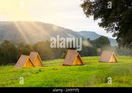 Cabins under the pine forest in sunset at Santuario de las Luciernagas forest in tlaxcala, Mexico. Stock Photo