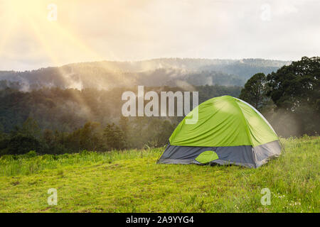 Camping and tent  under the pine forest in sunset at Santuario de las Luciernagas forest in tlaxcala, Mexico. Stock Photo