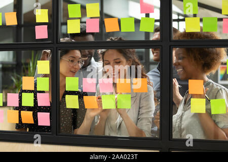 Diverse teammates satisfied with working process at office. Stock Photo