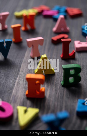 Colorful wooden letters on wooden background, close up Stock Photo