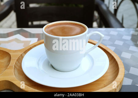 Cup of Turkish Coffee on Wooden Tray Served at the Outdoor Seating Stock Photo