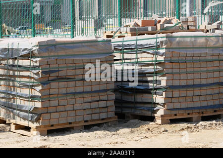Construction Materials. Pile of gray bricks at construction site. Building materials for construction of building. Stock Photo