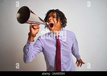Young african american businessman screaming using vintage megaphone Stock Photo