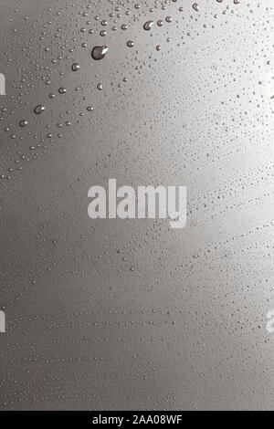 Background of shining water drops on silvery surface, macro Stock Photo