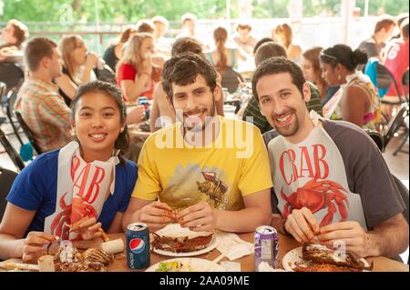 Students participate in a Crab Feast, with Maryland blue crabs, an annual tradition at the Johns Hopkins University in Baltimore, Maryland, May 15, 2009. From the Homewood Photography collection. () Stock Photo