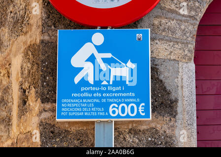 Mallorca, Spain - May 10,2019: Clean up after dog sign on street in Old Town of Alcudia. Majorca, Spain Stock Photo
