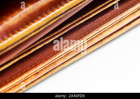 Detail of an old leather bag briefcase on white background close up Stock Photo