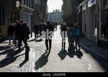 Crowds of people and winter shadows on Trinity Street Cambridge Stock Photo