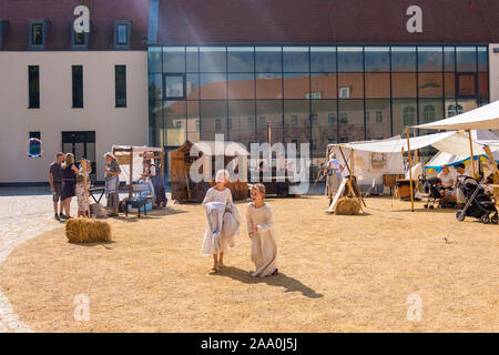 Bautzen, Germany - September 1, 2019: The boy launches huge soap bubbles. Historical reconstruction at the Old Town Festival in Bautzen, Upper Lusatia Stock Photo