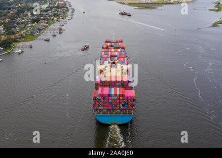 Aerial view of cargo ship entering port. Stock Photo