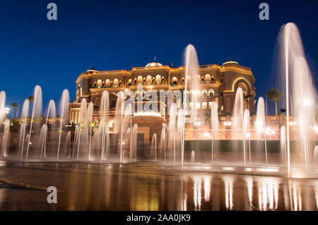 Abu Dhabi, United Arab Emirates - November 1, 2019: Emirates palace in Abu dhabi reflected on the ground level fountain at blue hour Stock Photo