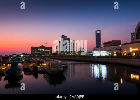 Abu Dhabi, United Arab Emirates - October 28, 2019: Abu Dhabi modern skyline reflected in the water of Al Bateen marina at twilight Stock Photo