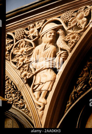 A falconer and hawk carved on a wooden stall in the choir at the english medieval cathedral of Winchester, England. Stock Photo