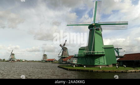 AMSTERDAM, NETHERLANDS-OCTOBER, 12, 2017: three windmills at zaanse schans near amsterdam Stock Photo