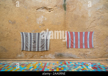 Fez, Morocco. November 9, 2019.   two crafted hooks hanging on the wall on a street decorated with colored tiles Stock Photo