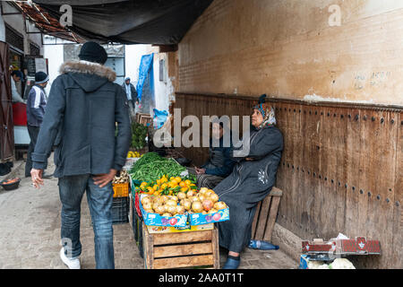 Fez, Morocco. November 9, 2019. people among the fruit and vegetable stalls of the street market in the old Jewish quarter Stock Photo