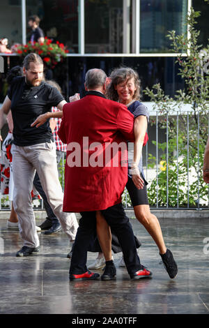 Man in red teddy boy drape dancing with gray-haired woman Stock Photo