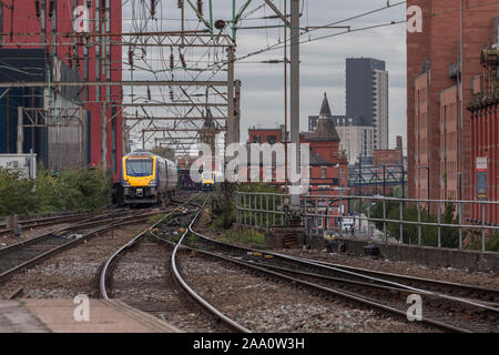 Arriva Northern rail class 195 trains passing on the congested 2 track railway in Castlefield, Manchester at Manchester Oxford Road / Deansgate Stock Photo