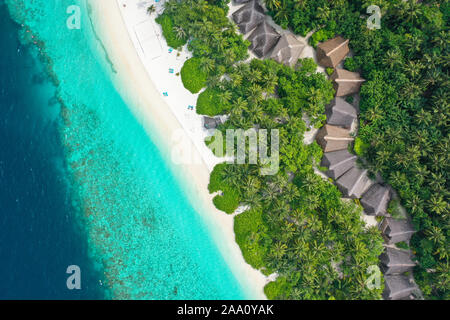 Aerial top down view with drone of an tropical exotic island paradise with turquoise crystal clear water and pure white sand beach