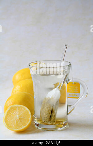Eine Tasse Kamillentee  mit Zitronen  / A cup of chamomile tea with lemons Stock Photo