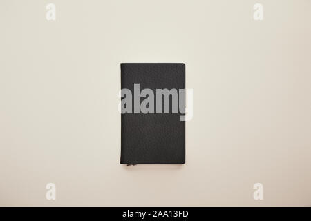 top view of black notebook isolated on beige Stock Photo