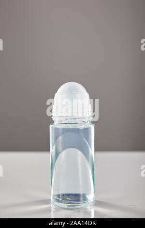 roll on bottle of deodorant on marble table isolated on grey Stock Photo