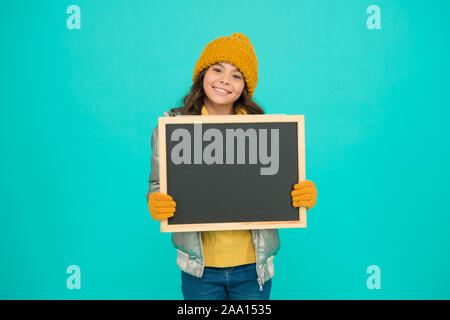 Open hours. Winter entertainment and activities. Happy hours. Promotion concept. Smiling girl wear winter outfit show blank chalkboard copy space. Fresh information. Schedule and working hours. Stock Photo