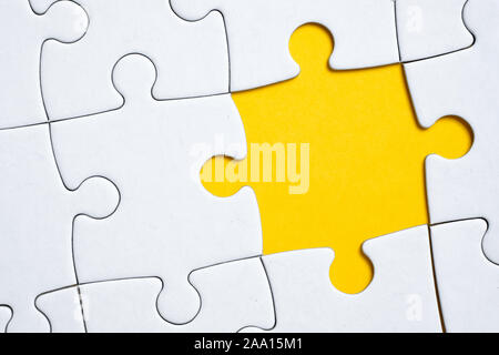 A piece of the puzzle is missing in the overall pattern or picture. The concept of absence. Close up. Stock Photo