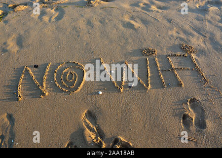 The word NO WI-FI  written on a sandy beach. Stock Photo