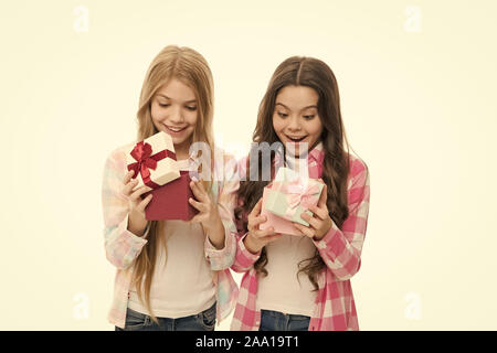 Intriguing moment. Birthday present. Girls sisters or friends hold gift boxes. Small girls open holiday present. Children excited cheerful faces hold presents. Opening gifts. Perfect present for teen. Stock Photo