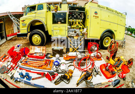 A collection of equipment carried by a heavy rescue fire truck in Orange, CA, includes chainsaws, fan, electric generator, axes, jacks, shovels and breathing equipment. Stock Photo